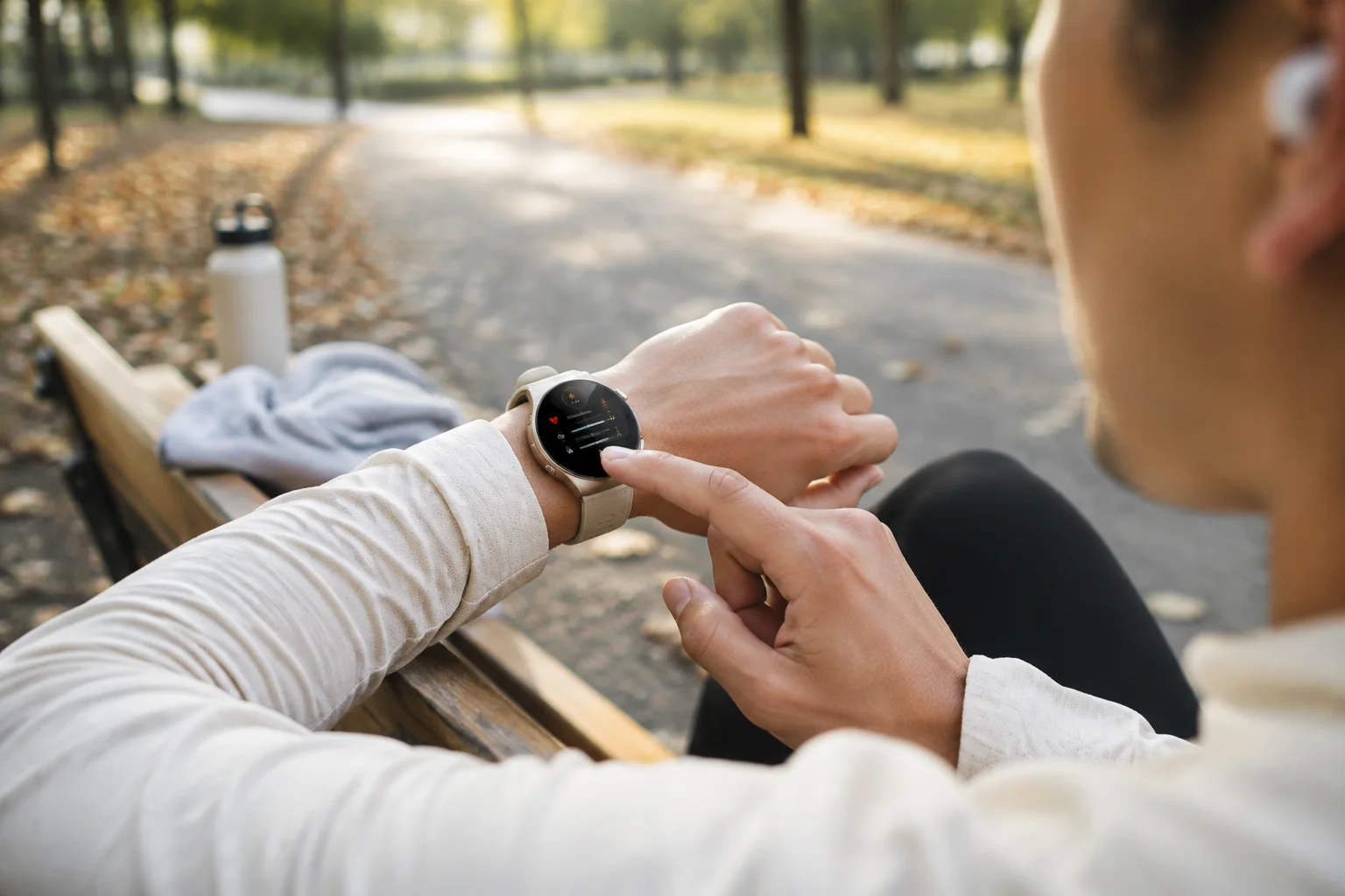 Runner checking a SAYDIAN W8 Ultra-R after a park workout