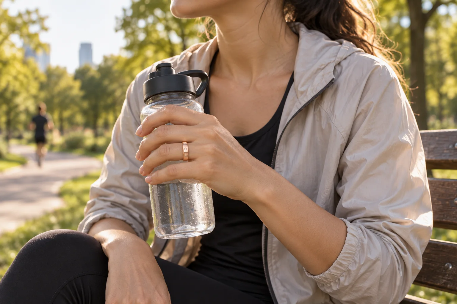 A runner wearing the SAYDIAN R7Y smart ring beside a park path